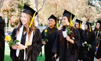 students at their graduation wearing caps and gowns